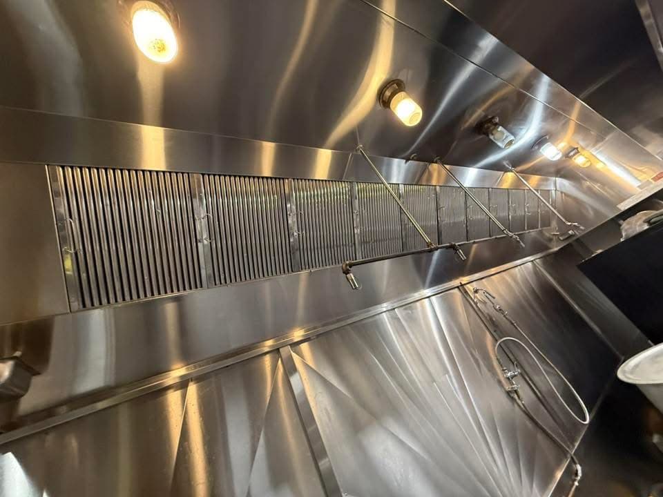 Clean stainless steel kitchen exhaust hood and baffle filters after professional cleaning